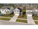 Aerial view of modern homes with driveways and garages in a suburban neighborhood with mature trees at 332 Long Pier St, Summerville, SC 29486