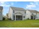 Spacious backyard showcasing a screened porch and well-maintained landscaping at 332 Long Pier St, Summerville, SC 29486