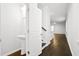 Hallway view featuring a pedestal sink in half bathroom with stylish door to adjacent staircase at 332 Long Pier St, Summerville, SC 29486