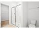Bright bathroom featuring a glass enclosed shower, toilet, and towel rack at 332 Long Pier St, Summerville, SC 29486
