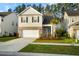 Charming two-story home with a brick-accented facade, well-manicured lawn, and a two-car garage at 332 Long Pier St, Summerville, SC 29486