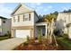 Charming two-story home with a garage, a mix of siding and brick, and beautiful landscaping at 332 Long Pier St, Summerville, SC 29486