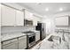 Modern kitchen featuring stainless steel appliances, gray countertops, and white cabinets at 332 Long Pier St, Summerville, SC 29486