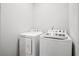 Bright laundry room with a white front load dryer and top load washer at 332 Long Pier St, Summerville, SC 29486