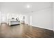 Open floor plan with hardwood floors connecting the kitchen with a view of an adjacent living area at 332 Long Pier St, Summerville, SC 29486