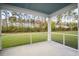 Relaxing screened porch with views of the backyard and surrounding trees at 332 Long Pier St, Summerville, SC 29486