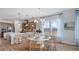 Sunlit dining area with a round table, stylish chandelier, and scenic views from the large windows at 352 Trailmore Ln, Summerville, SC 29486