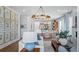 Sunlit living room showcasing stylish decor, hardwood floors, and an open floor plan that flows into the kitchen at 352 Trailmore Ln, Summerville, SC 29486