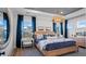 Bedroom showcasing hardwood floors, a statement light fixture, and natural light from two windows at 352 Trailmore Ln, Summerville, SC 29486