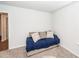 Neutral guest room with beige couch, blue blanket, and patterned throw pillows, featuring carpet flooring at 369 Spruce Ivy St, Moncks Corner, SC 29461