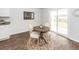 Cozy dining area with a round table, stylish chairs, and natural light from a sliding glass door creating a charming space at 369 Spruce Ivy St, Moncks Corner, SC 29461