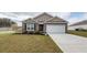 Attractive one-story home with brick accents, a two-car garage, and a well-maintained front yard at 369 Spruce Ivy St, Moncks Corner, SC 29461