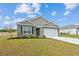 Lovely single-Gathering home featuring a mix of brick and vinyl siding, a two-car garage, and green grass at 369 Spruce Ivy St, Moncks Corner, SC 29461