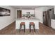 Modern kitchen island with seating, stainless appliances, and sleek white cabinetry creating a welcoming and functional space at 369 Spruce Ivy St, Moncks Corner, SC 29461