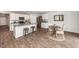 Well-designed kitchen with a central island, stainless appliances, and adjacent dining area, perfect for gatherings and meals at 369 Spruce Ivy St, Moncks Corner, SC 29461