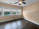 Cozy bedroom with hardwood floors, a ceiling fan, neutral walls, and lots of natural light at 3700 Maidstone Dr, Mount Pleasant, SC 29466