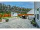 Spacious paved patio in fenced backyard with an outdoor kitchen, shed, and serene natural surroundings at 4314 Cotton Flt Rd, Summerville, SC 29485