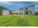 Spacious backyard with lush green grass and a stone patio that is perfect for outdoor entertaining at 4314 Cotton Flt Rd, Summerville, SC 29485