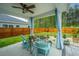 Cozy covered patio with stylish decor, overlooking a fenced backyard oasis and lush greenery at 4314 Cotton Flt Rd, Summerville, SC 29485