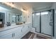 Modern bathroom featuring a double vanity, glass-enclosed shower, and stylish fixtures at 4314 Cotton Flt Rd, Summerville, SC 29485