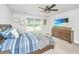 Bright bedroom featuring a ceiling fan, furniture set, and a peaceful backyard view at 4314 Cotton Flt Rd, Summerville, SC 29485