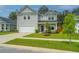 Attractive two-story home with a two-car garage, beautiful lawn, and charming landscaping at 4314 Cotton Flt Rd, Summerville, SC 29485