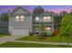 Charming two-story home with grey siding, well-manicured lawn, and attached two-car garage at 4314 Cotton Flt Rd, Summerville, SC 29485