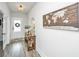 Inviting foyer featuring a light fixture, entryway table, a world map and a door with a wreath at 4314 Cotton Flt Rd, Summerville, SC 29485