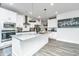 Bright kitchen features an island with gray countertop, stainless steel appliances and white cabinetry at 4314 Cotton Flt Rd, Summerville, SC 29485