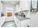 Kitchenette with white cabinets, sink, and window at 4314 Cotton Flt Rd, Summerville, SC 29485