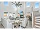 Bright living room with high ceilings, fireplace, ceiling fan, and comfortable seating at 4314 Cotton Flt Rd, Summerville, SC 29485