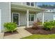 Inviting front porch with elegant columns, tasteful landscaping, and a welcoming wreath on the door at 4314 Cotton Flt Rd, Summerville, SC 29485