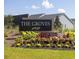 The Groves community sign with lush landscaping and well-maintained lawn at 455 White Magnolia St, Moncks Corner, SC 29461