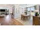 Bright dining room features a modern chandelier, area rug, and outdoor view from large windows at 455 White Magnolia St, Moncks Corner, SC 29461