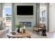 Living room features fireplace with tv, large windows with view of the outdoors, and modern decor at 455 White Magnolia St, Moncks Corner, SC 29461