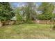 Spacious backyard with a grass lawn and wood fence, offering privacy and outdoor enjoyment at 4971 Edge Ave, Charleston, SC 29405