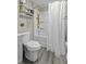 Bright bathroom with a white toilet, shower-tub, and decorative shelving at 4971 Edge Ave, Charleston, SC 29405