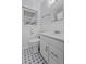 Well-lit bathroom with a white vanity, patterned flooring, and large window at 4971 Edge Ave, Charleston, SC 29405