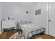 Serene bedroom with wood floors, a comfy bed, a sewing machine, and soft gray walls at 4971 Edge Ave, Charleston, SC 29405