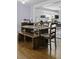 Charming dining area connected to a functional kitchen with laundry, perfect for modern living and convenience at 4971 Edge Ave, Charleston, SC 29405
