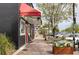 Charming sidewalk featuring multiple business exteriors decorated with greenery and outdoor seating at 4971 Edge Ave, Charleston, SC 29405