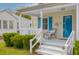 Charming front porch with a cozy seating area, offering a welcoming entrance to this delightful home at 4971 Edge Ave, Charleston, SC 29405