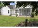 Charming backyard with a screened porch and well-kept lawn enhances outdoor living at 518 Antebellum Ln, Mount Pleasant, SC 29464