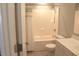 Bright bathroom with tiled shower-tub, white cabinets, and tile floors offers a clean and modern space at 518 Antebellum Ln, Mount Pleasant, SC 29464
