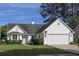 Charming one-story home with light blue door, white siding, well-maintained lawn, and mature trees at 518 Antebellum Ln, Mount Pleasant, SC 29464