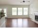 Spacious living room with hardwood floors, fireplace, built-in shelving, and a ceiling fan at 518 Antebellum Ln, Mount Pleasant, SC 29464