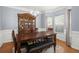 Inviting dining room featuring a wooden table, china cabinet, and a window with bright natural light at 5224 Stonewall Dr, Summerville, SC 29485