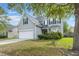 Attractive two-story home with a two-car garage, complemented by lush greenery and a mature tree at 5224 Stonewall Dr, Summerville, SC 29485