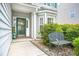 Charming front entrance with a decorative door, a cozy bench, and mature shrubbery at 5224 Stonewall Dr, Summerville, SC 29485