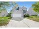 Inviting front exterior featuring a two-story home with an attached garage and a well-manicured lawn at 5224 Stonewall Dr, Summerville, SC 29485